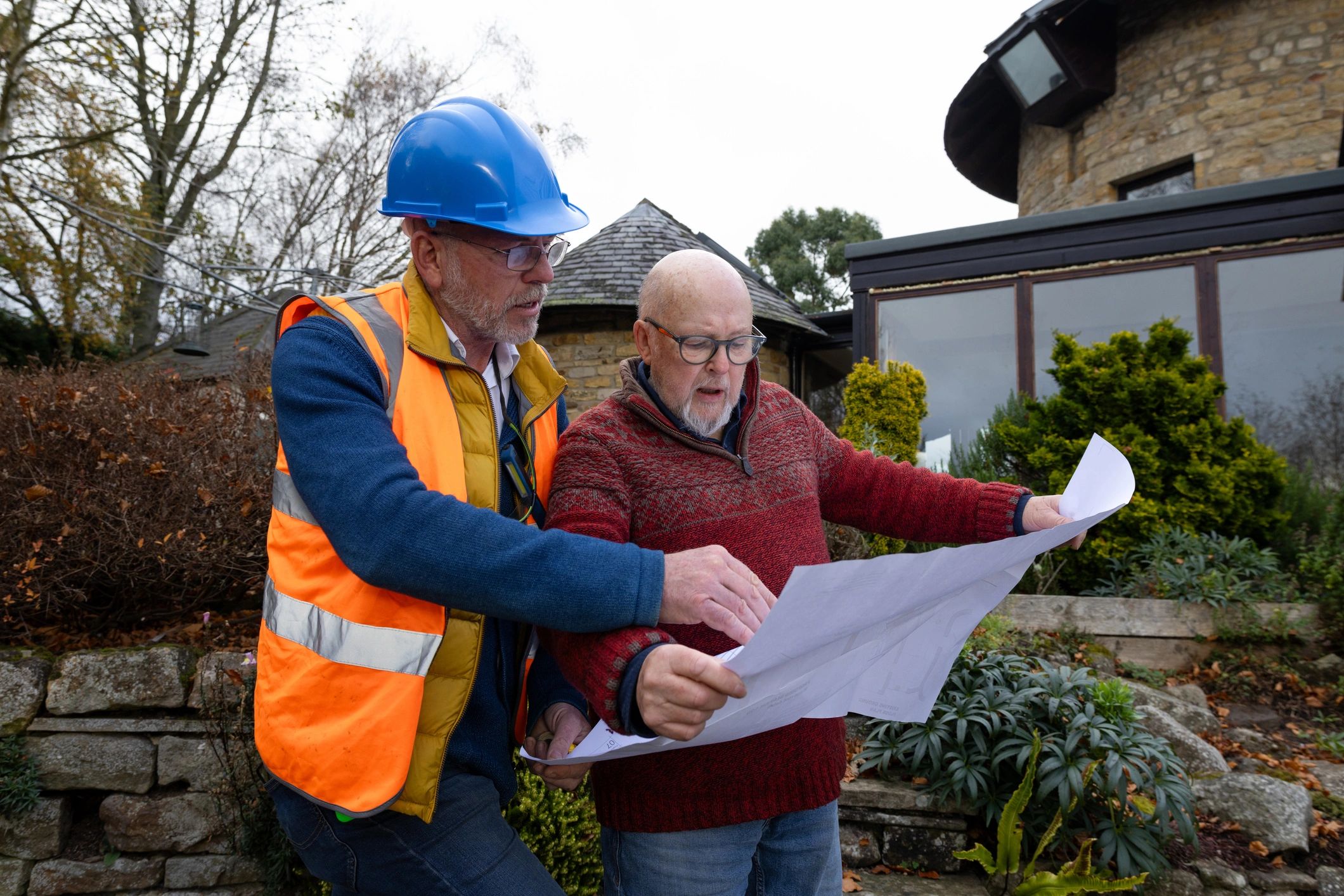 Construction consultant reviewing plans with client