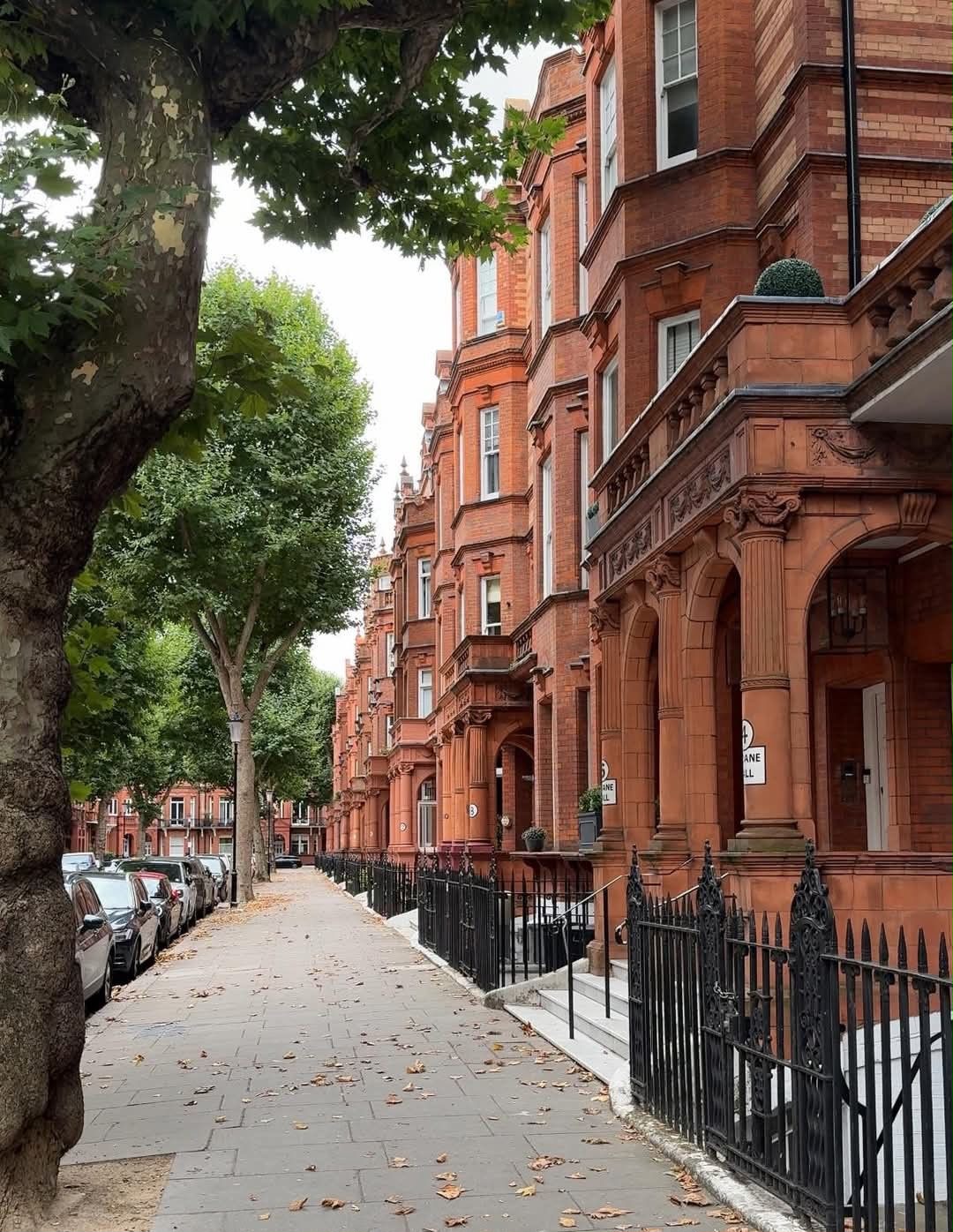 Residential project management in London: red-brick mansion blocks on a tree-lined street
